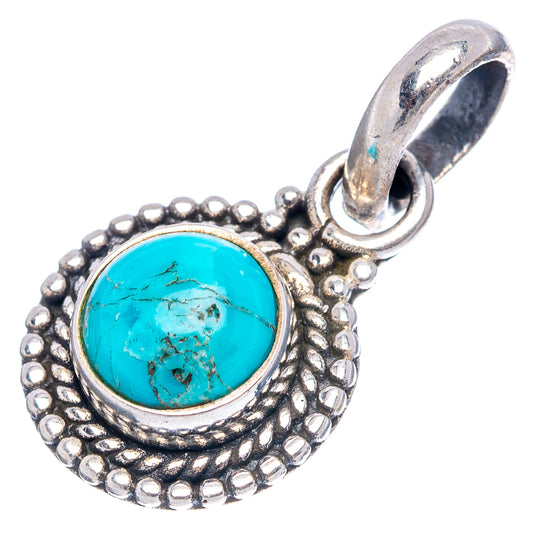Sterling silver turquoise pendant with round cabochon, ornate frame, and top loop bail