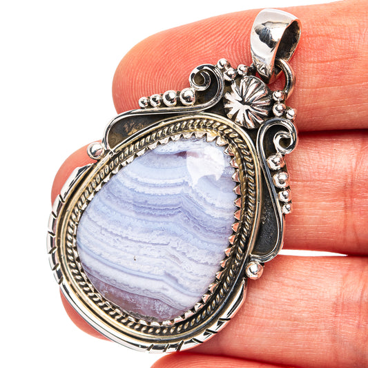 Sterling silver oval pendant with blue lace agate gemstone and ornate bezel
