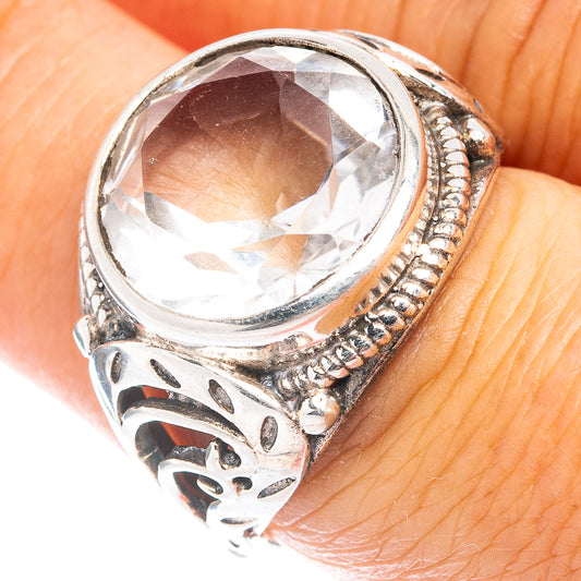 Sterling silver ring with large oval clear gemstone and ornate engraved band