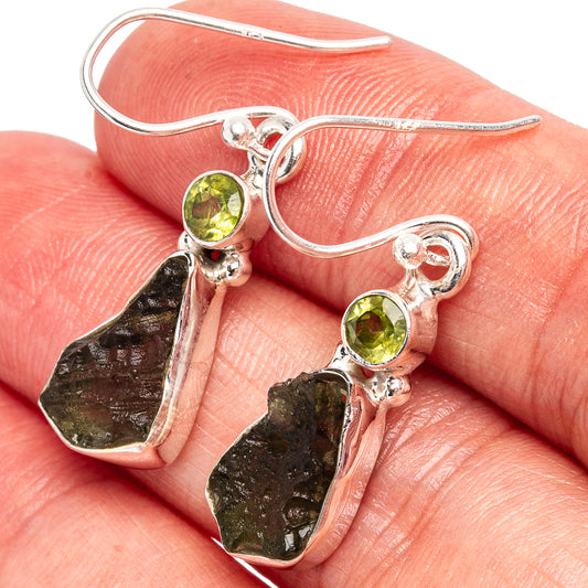 Sterling silver drop earrings with green round gemstones and irregular dark metal charms