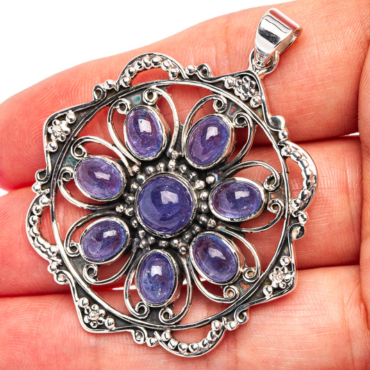 Sterling silver pendant with oval blue-purple tanzanite cluster and ornate filigree bail