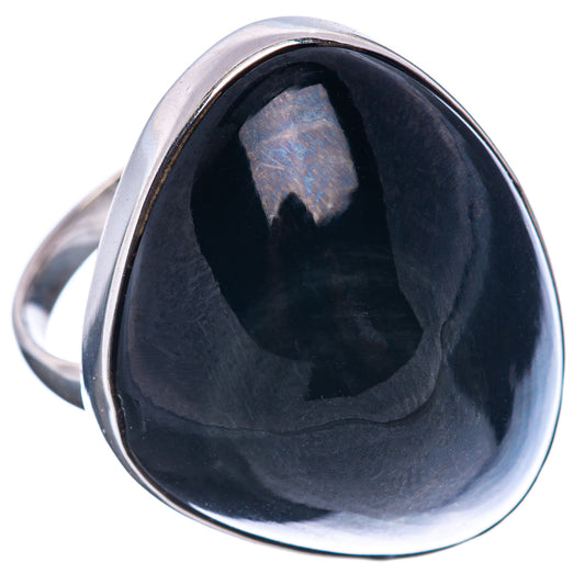 Sterling silver ring featuring a dark oval obsidian cabochon with glossy bezel.