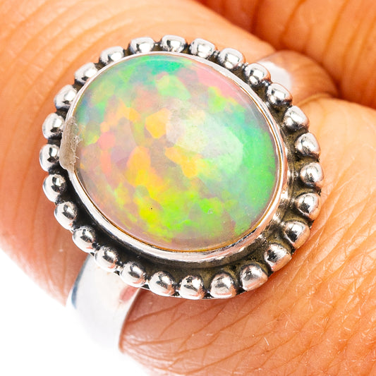 Oval opal ring in .925 sterling silver with beaded halo and prong bezel