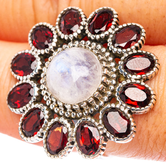 Sterling silver flower ring with moonstone center and dark red garnet accents