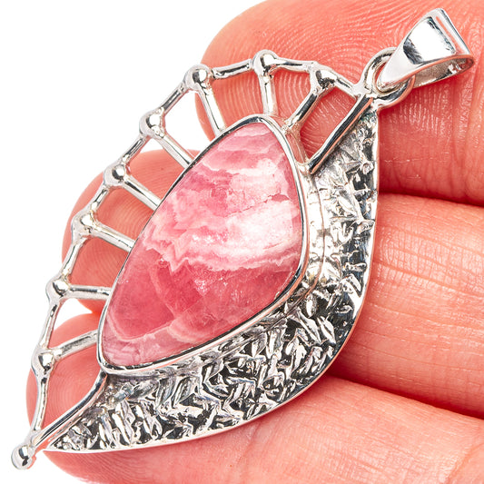Pink rhodochrosite teardrop pendant detail, .925 sterling silver textured bezel and bail.