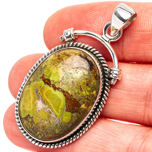 Oval sterling silver pendant with oval green-yellow-brown Gaspeite cabochon, rope bezel.