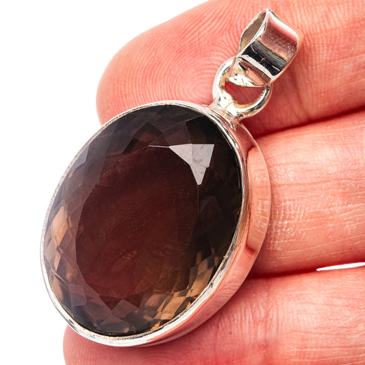 Oval faceted smoky quartz pendant in .925 sterling silver bezel with loop bail