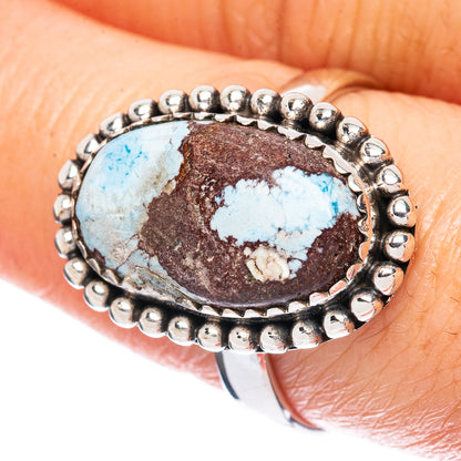 Turquoise oval sterling silver ring with beaded halo setting.