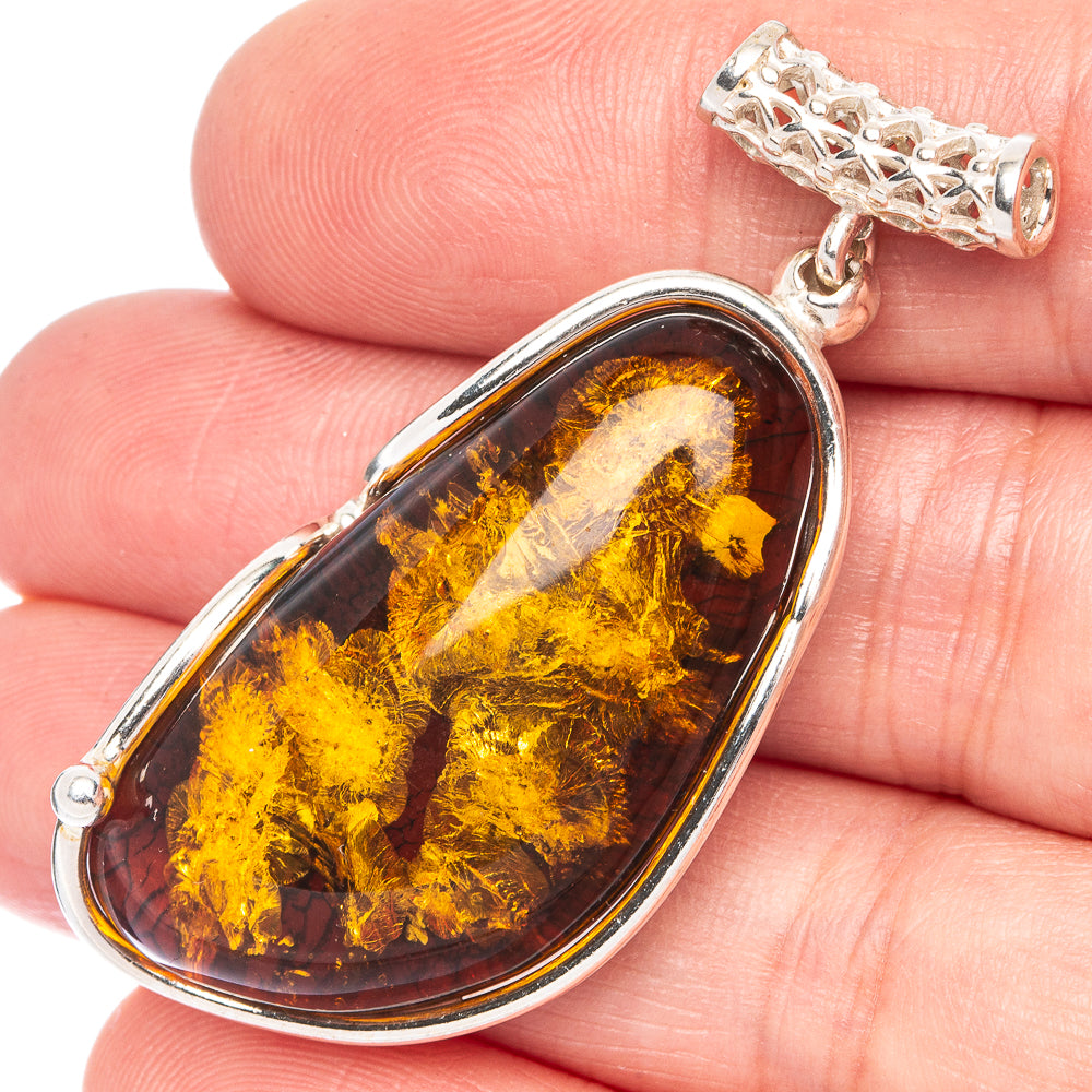 Oval amber cabochon pendant in 925 sterling silver, golden swirls with dark flecks