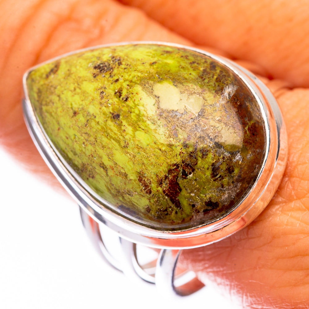 Sterling silver gaspeite ring with oval green stone, dark speckled pattern
