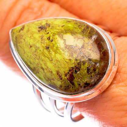 Sterling silver gaspeite ring with oval green stone, dark speckled pattern
