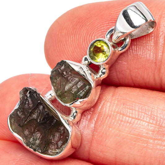 Sterling silver pendant with rough moldavite piece and round yellow-green peridot cabochon