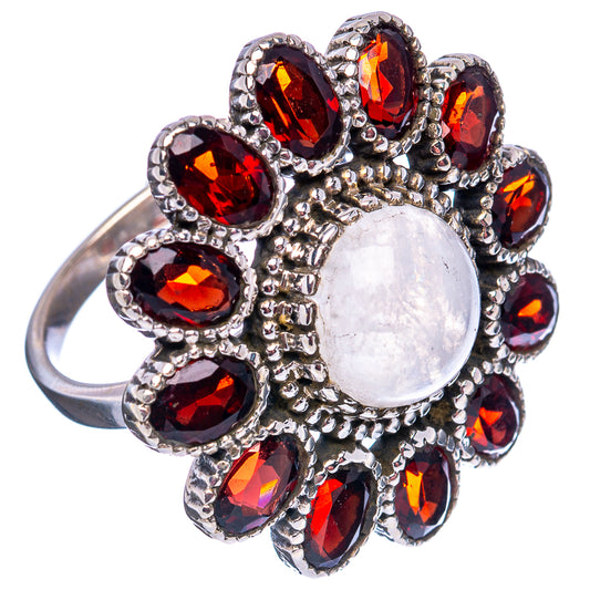 Round cabochon moonstone in silver flower ring with red garnet stones, size 8 band