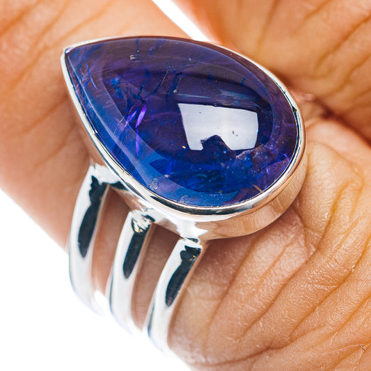 Pear-shaped blue gemstone on sterling silver ring, close-up