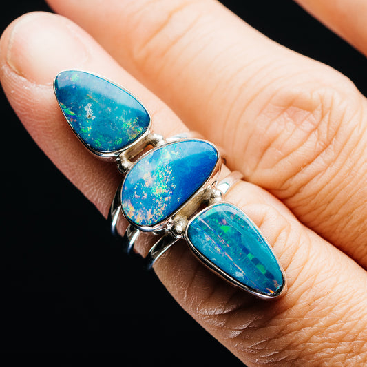 Sterling silver opal doublet ring with three blue teardrop stones on finger