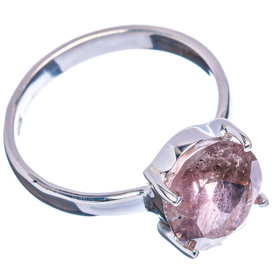 Sterling silver ring with large oval pink-purple gemstone in prong mount