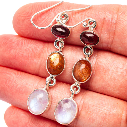 Sterling silver dangle earrings with red, orange, and white oval gemstones, linked drops