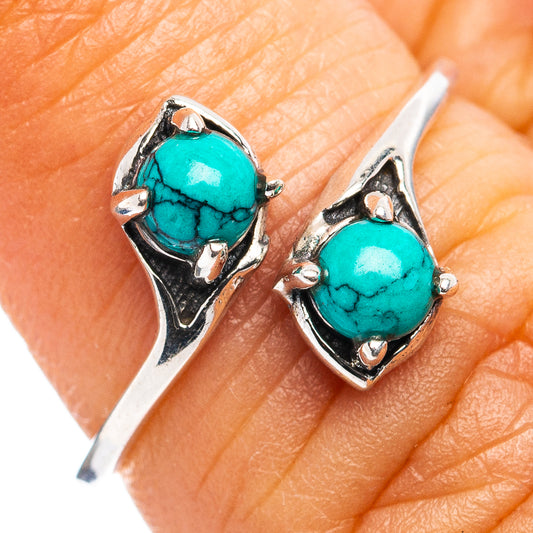 Sterling silver dainty ring close-up with two turquoise cabochon stones in openwork bezels
