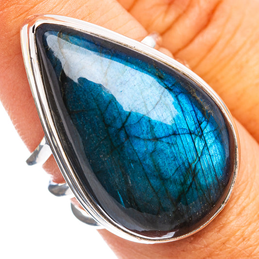Sterling silver ring close-up with teardrop labradorite stone, vivid blue flash, bezel set