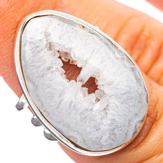 Sterling silver oval geode slice ring with white crystal pattern, close-up.
