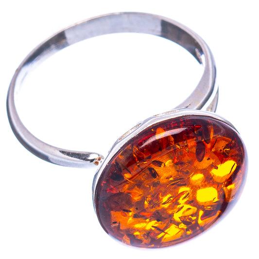 Adjustable sterling silver ring with oval amber cabochon and openwork band