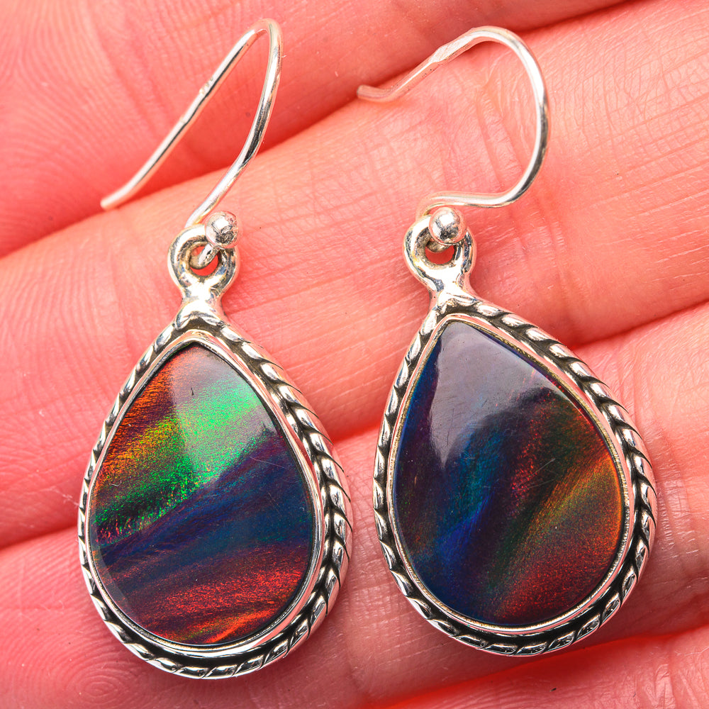 Sterling silver opal teardrop earrings with iridescent multicolor stone and rope-edge border