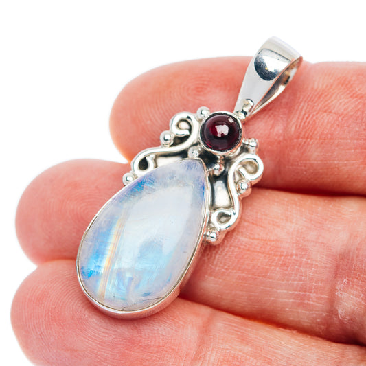 Sterling silver pendant with teardrop rainbow moonstone and small red garnet stone