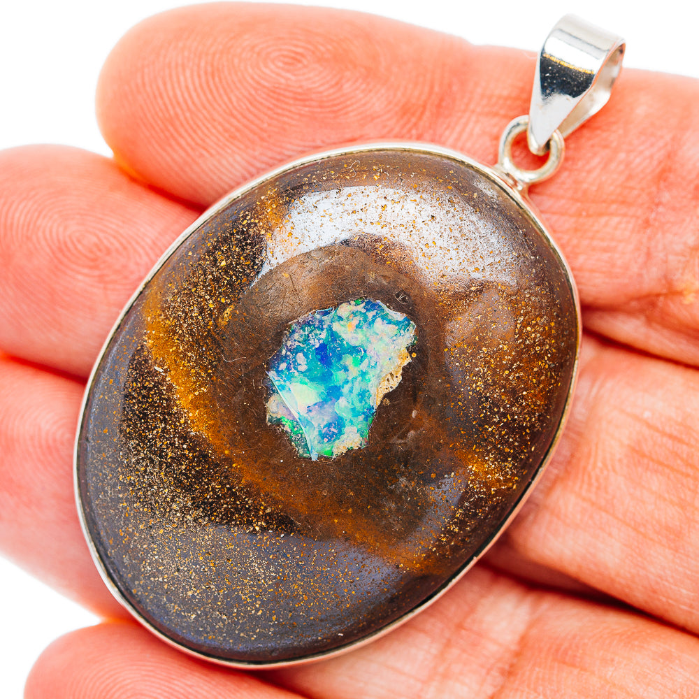 Sterling silver pendant with round boulder opal cabochon and hinged bail