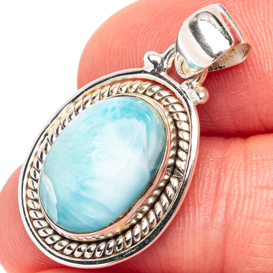 Sterling silver larimar pendant with oval blue gemstone and ornate bezel, on bail