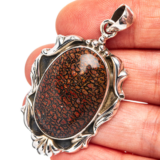 Dinosaur bone pendant in .925 sterling silver, oval textured stone in ornate frame