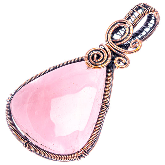 Rose quartz teardrop pendant in oxidized copper wire wrap with layered spiral loops