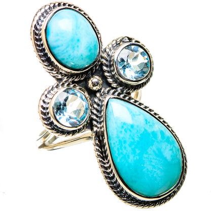 Silver statement ring with large oval turquoise stone and three blue round gemstones