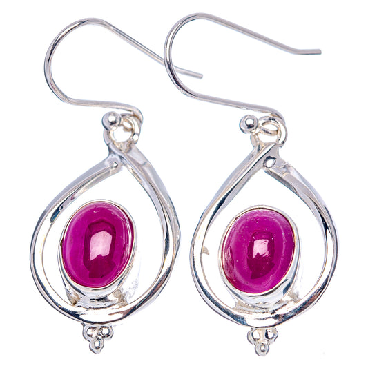 Sterling silver teardrop earrings with oval purple ruby cabochon and ornate halo