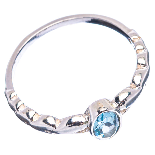 Sterling silver band ring with oval blue topaz bezel and decorative cutout links