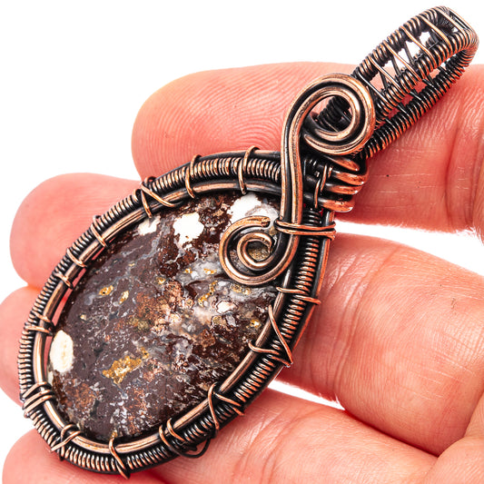 Oxidized copper wire-wrapped jasper pendant with teardrop stone and coil frame