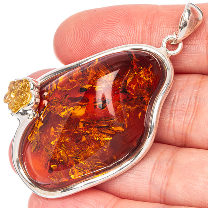 Baltic amber teardrop pendant in sterling silver bezel, close-up on bail