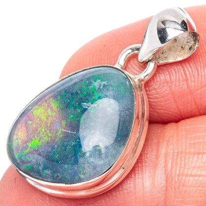 Oval opal pendant in sterling silver with hinged bail, close-up on colorful stone