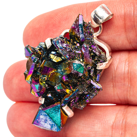 Sterling silver aura quartz pendant with colorful crystal cluster, shown on finger
