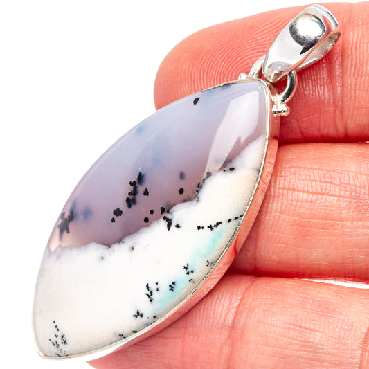 Sterling silver dendritic opal pendant with teardrop cabochon and loop bail, close-up
