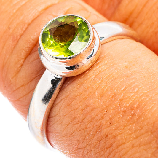 Faceted peridot ring in .925 sterling silver, green gemstone close-up on band