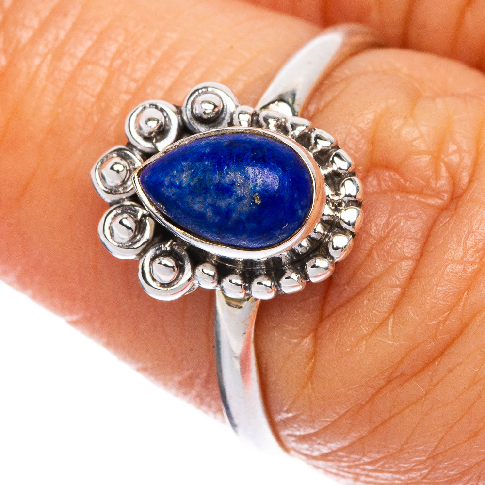 Sterling silver ring with oval blue lapis cabochon and scalloped halo design
