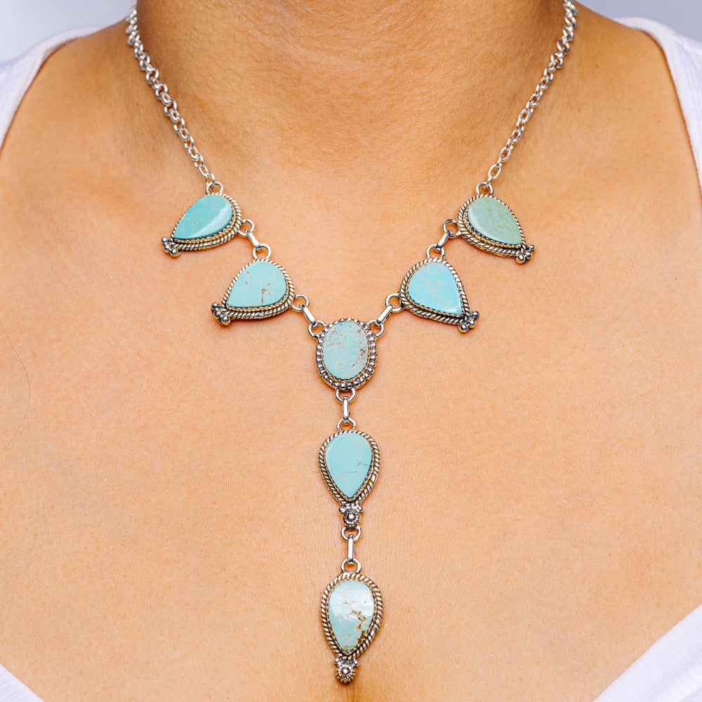 Turquoise teardrop silver necklace with linked chain and multiple blue stone drops