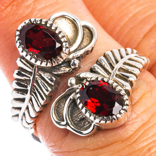Adjustable sterling silver ring with two faceted garnet-style stones on openwork band