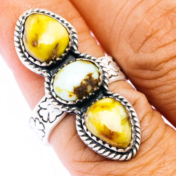 Sterling silver ring with three oval yellow and white gemstone cabochons, braided bezels