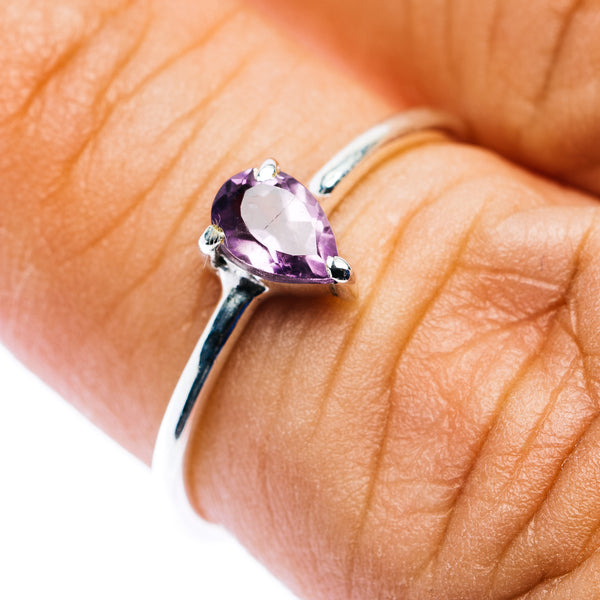 Sterling silver amethyst ring with faceted purple oval gemstone, close-up
