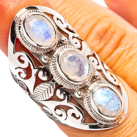 Sterling silver oval moonstone cuff ring with ornate filigree and three iridescent stones