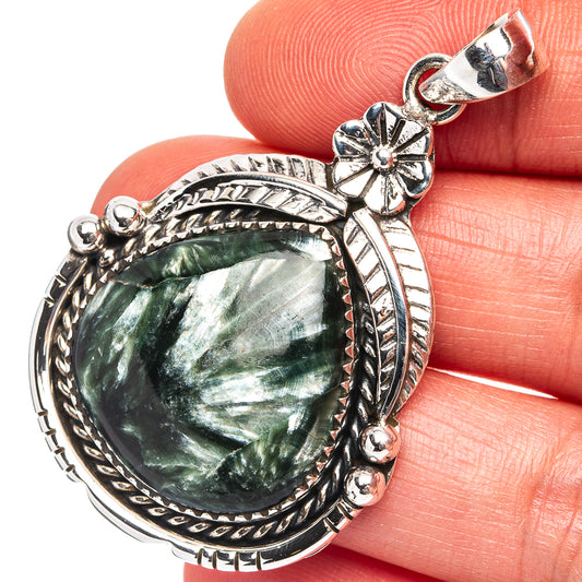 Round green seraphinite cabochon pendant in .925 sterling silver, ornate floral bail
