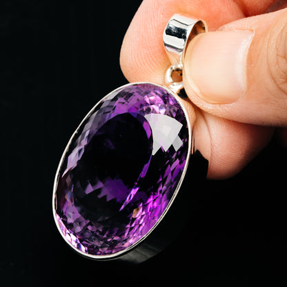 Oval faceted amethyst pendant in .925 sterling silver bezel, shown from side