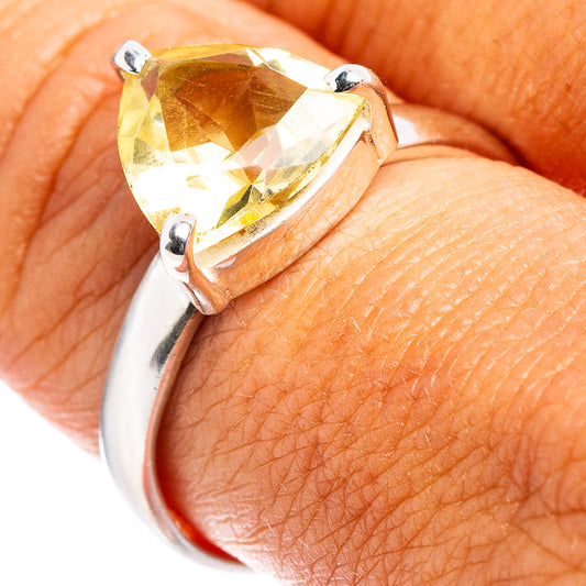 Sterling silver ring with faceted lemon quartz center and prong setting on finger