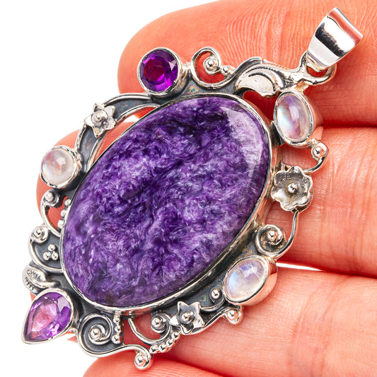 Oval purple charoite pendant with amethyst and moonstone accents, .925 sterling silver bail